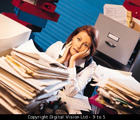 woman stressed out behind piles if paperwork on a desk exhibiting that carpe scuba is your stress relief