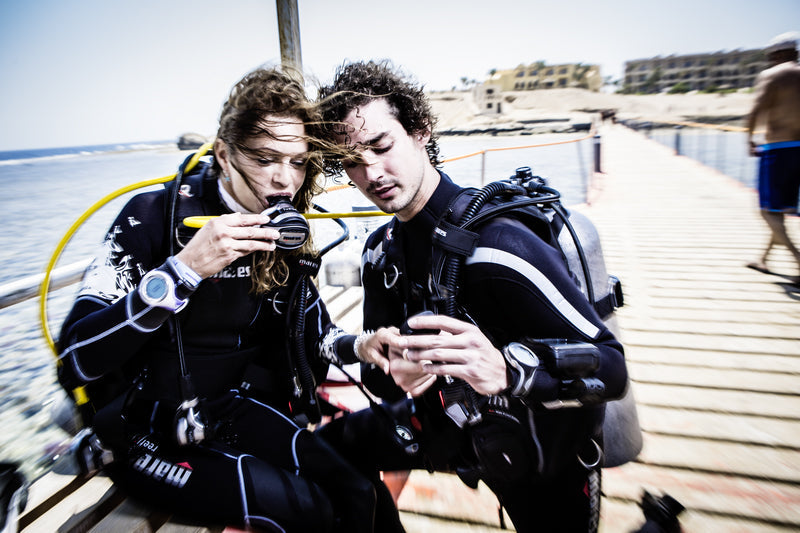 two scuba divers checking their dive equipment prior to joining an escorted dive with central coast divers